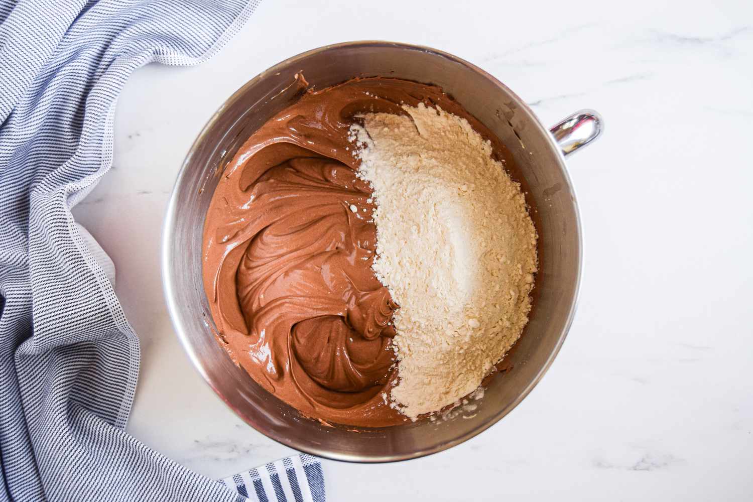 Chocolate Bourbon Cake batter with wet and dry ingredients in a bowl, ready to mix