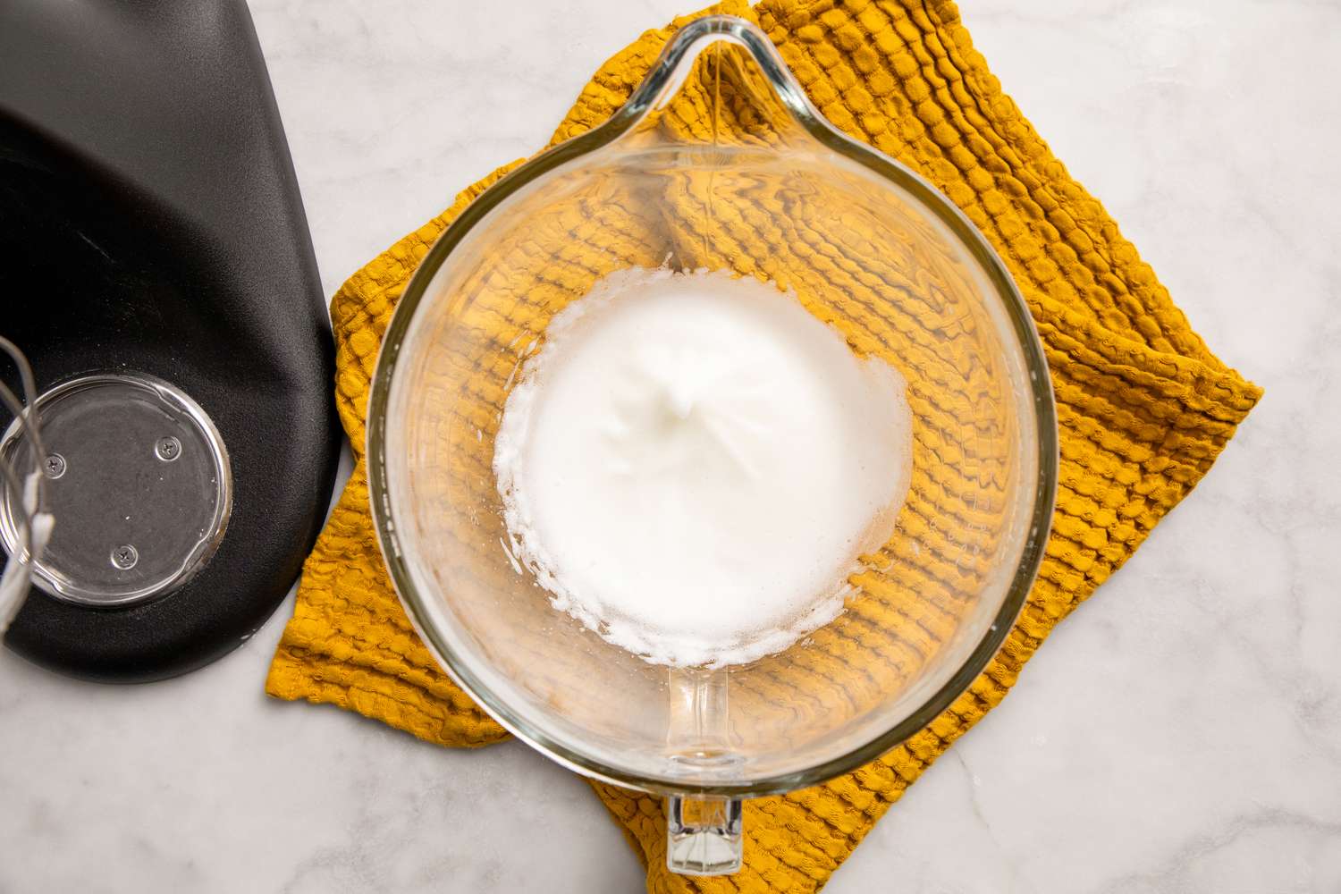 overhead view of whipped egg whites in mixer bowl for Southern Banana Pudding