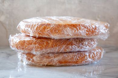 Three plastic wrapped cake layers to show how to freeze cake.