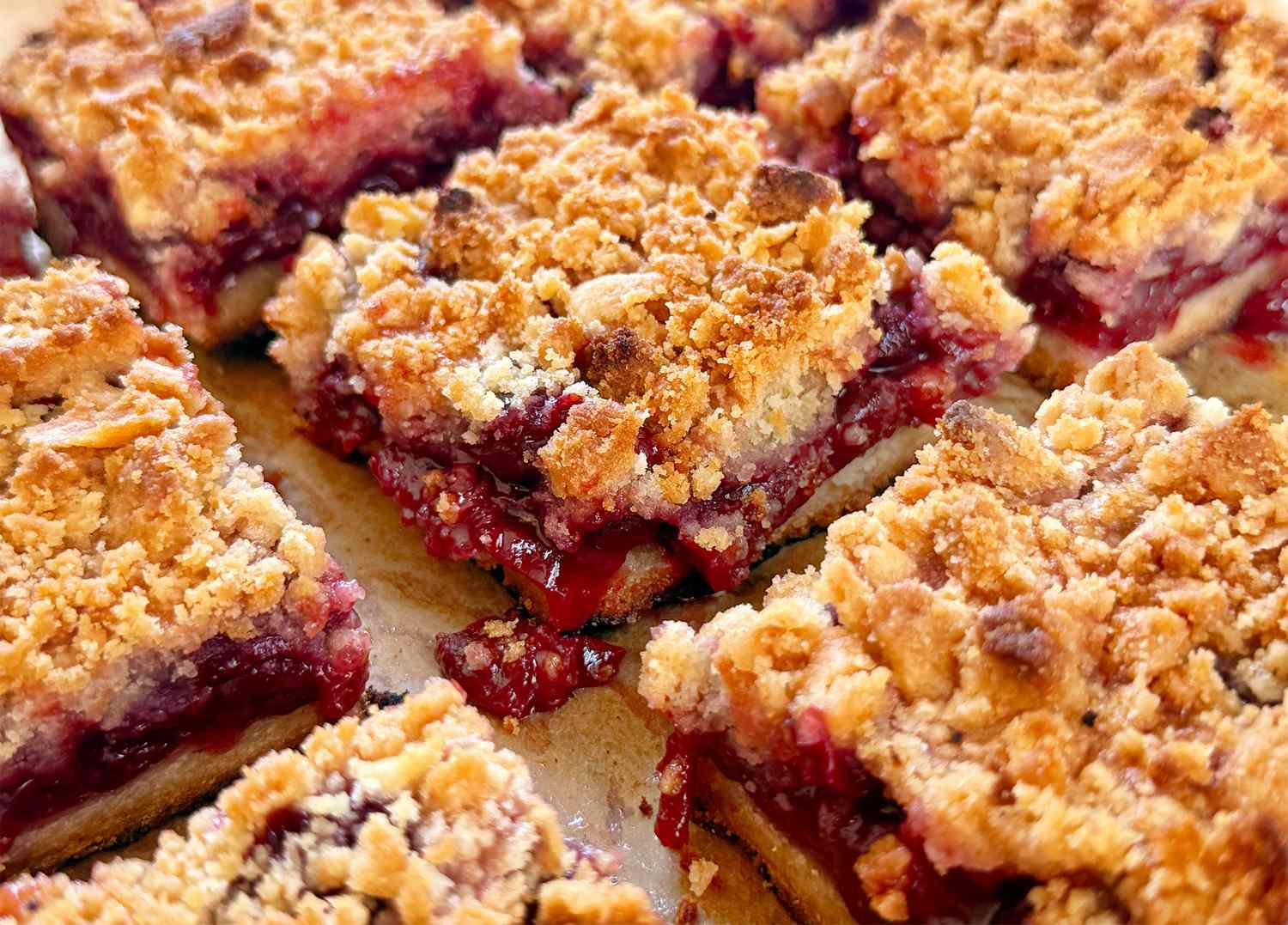 Cherry crumb dessert bars arranged closely