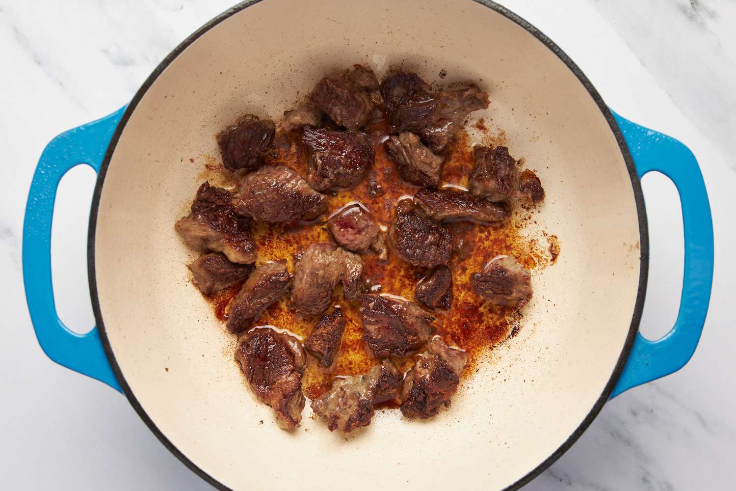 Chuck roast browned in a cast iron skillet for carne picada recipe