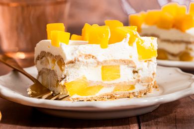 slice of mango float (mango royale) on a plate (close-up, cross-section cut facing forward)
