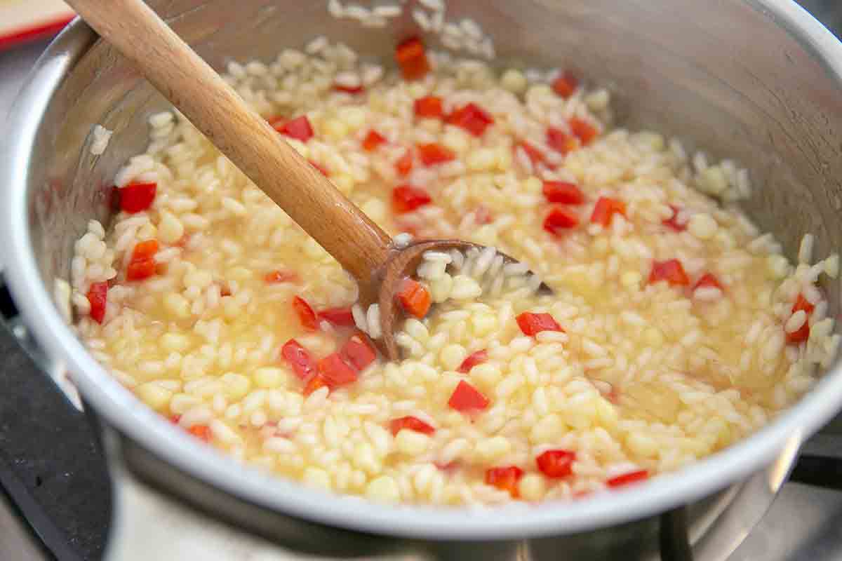 stir summer vegetable risotto in pot