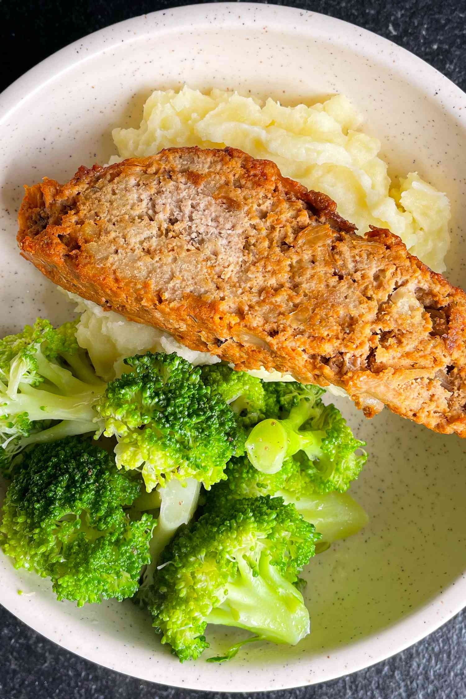 Meatloaf served with mashed potatoes and broccoli
