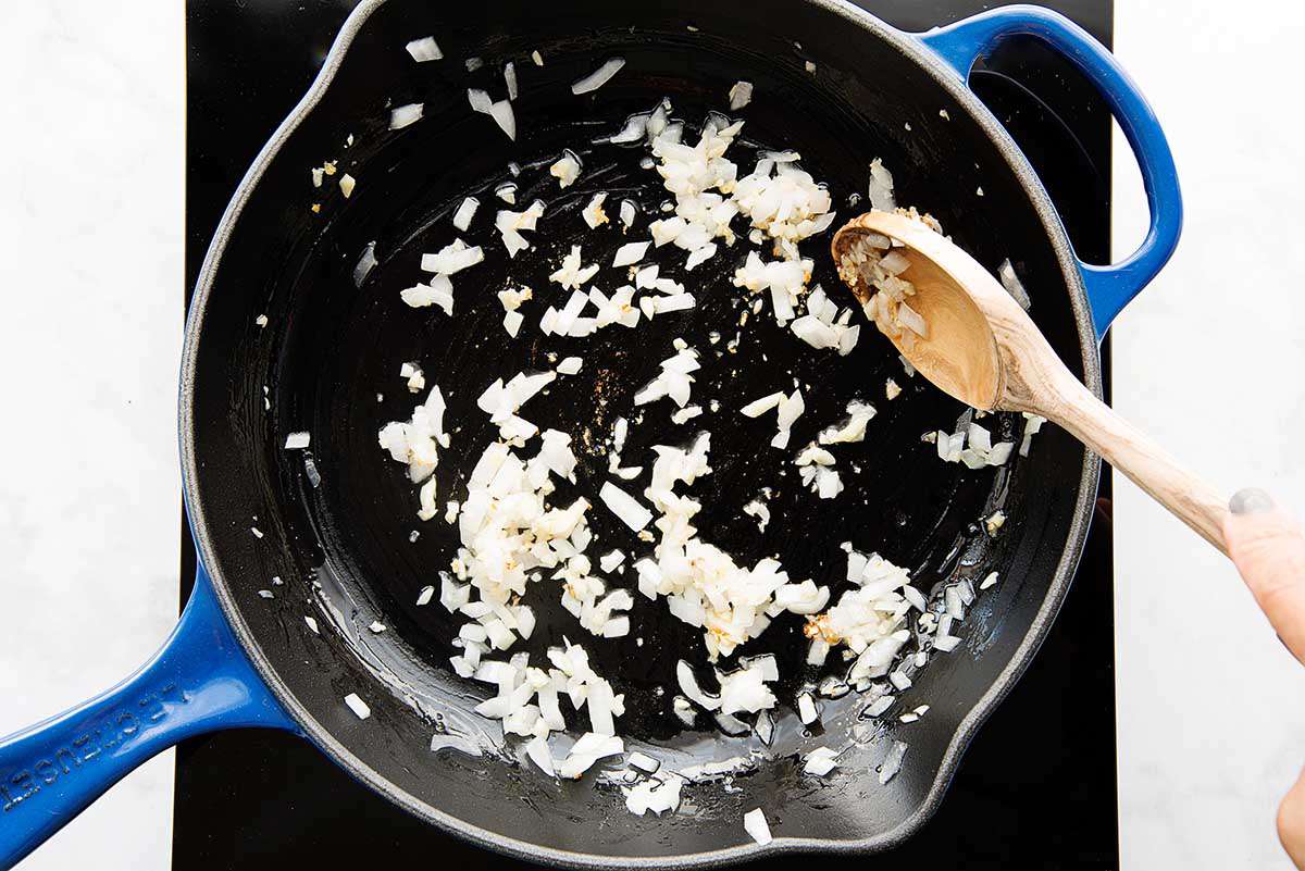 Onions sauteed in a cast iron skillet for homemade queso