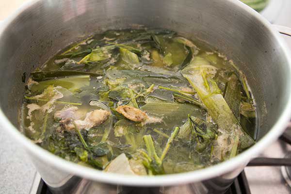 Boiling chicken and vegetables for chicken stock in a pot