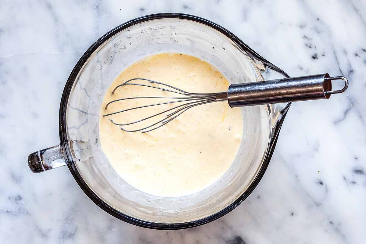 Low-Carb Quiche Recipe - - large mixing cup with whisk and egg and cream mixture