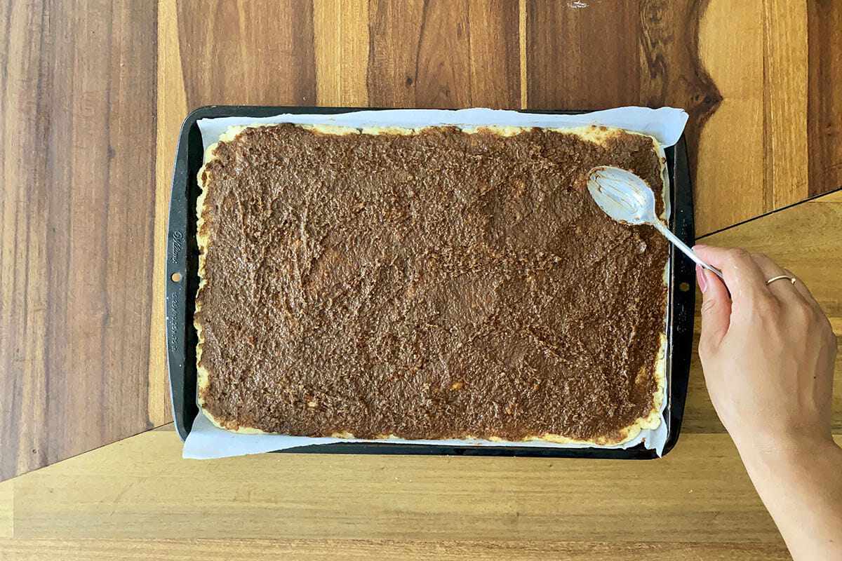 How to make gluten free cinnamon rolls by spreading the cinnamon mixture over the dough.