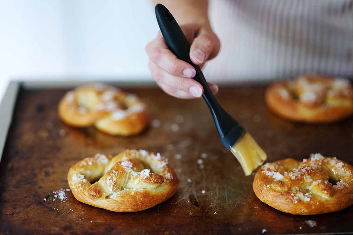Brush the baked pretzels with melted butter