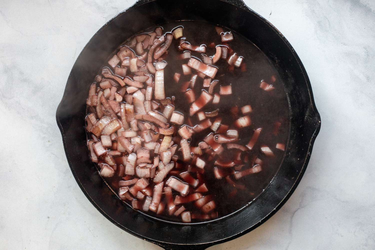 Onions and Red Wine in a Caste Iron Skillet for Crockpot Beef Stew