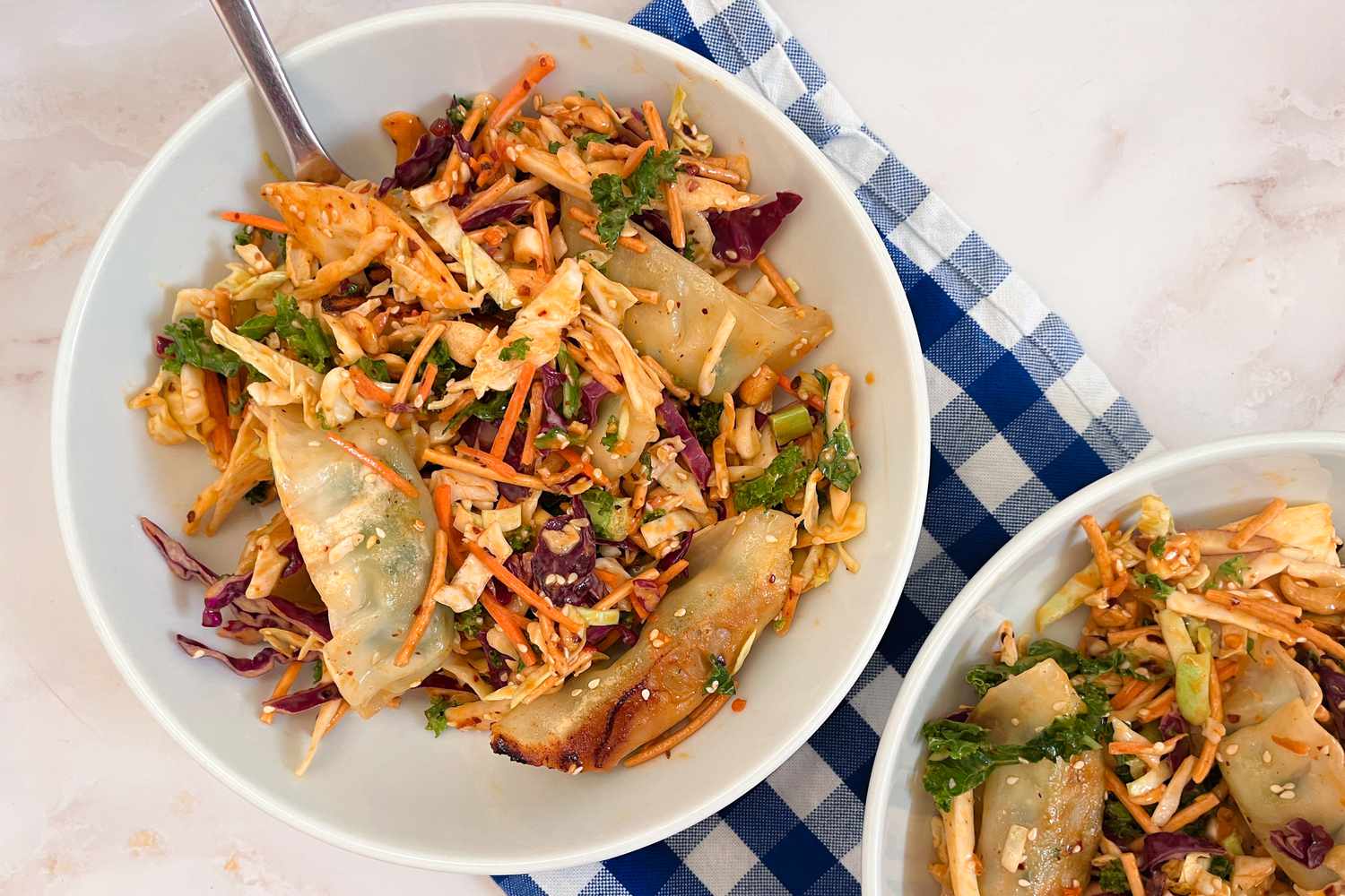 A bowl with the Trader Joe's Miso Crunch Chopped Salad Kit and dumplings