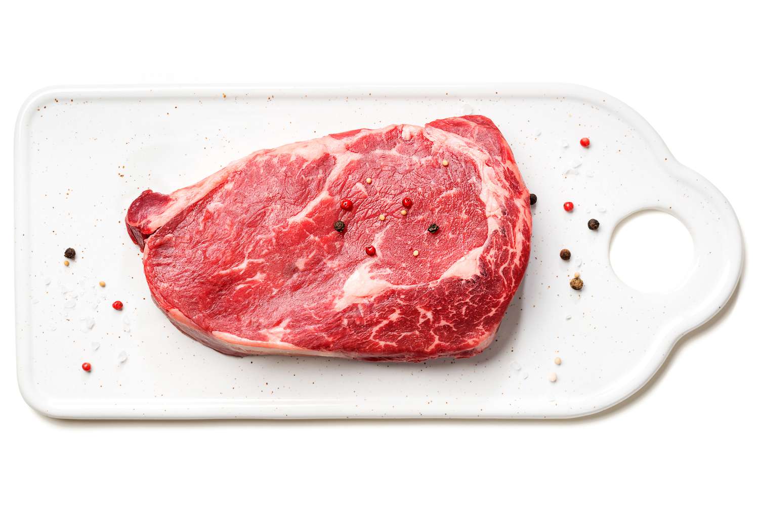 seasoned steak on a cutting board 