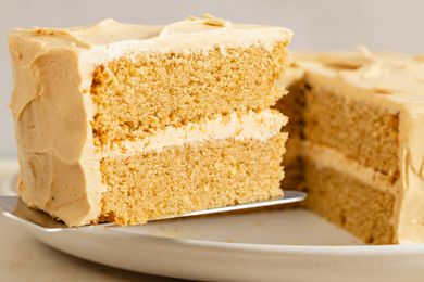 A slice of peanut butter cake with frosting on a plate