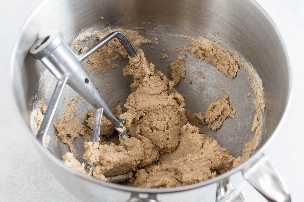 Dough for the best chocolate chip cookies in the bowl of a mixer.