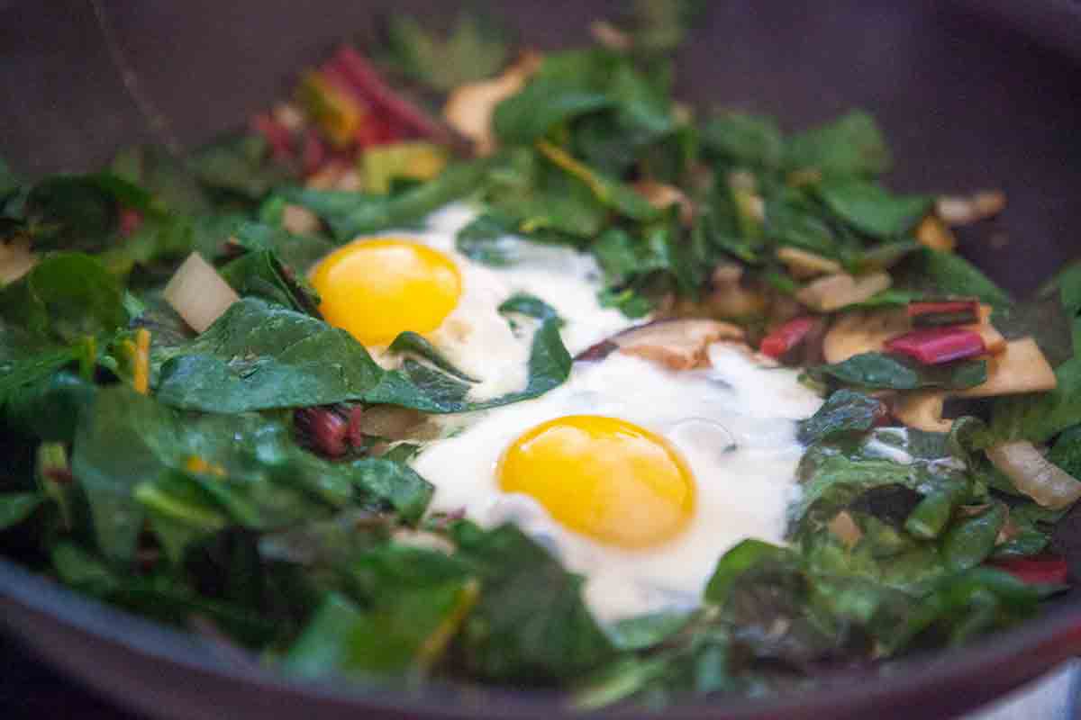 swiss chard cooked eggs in pan