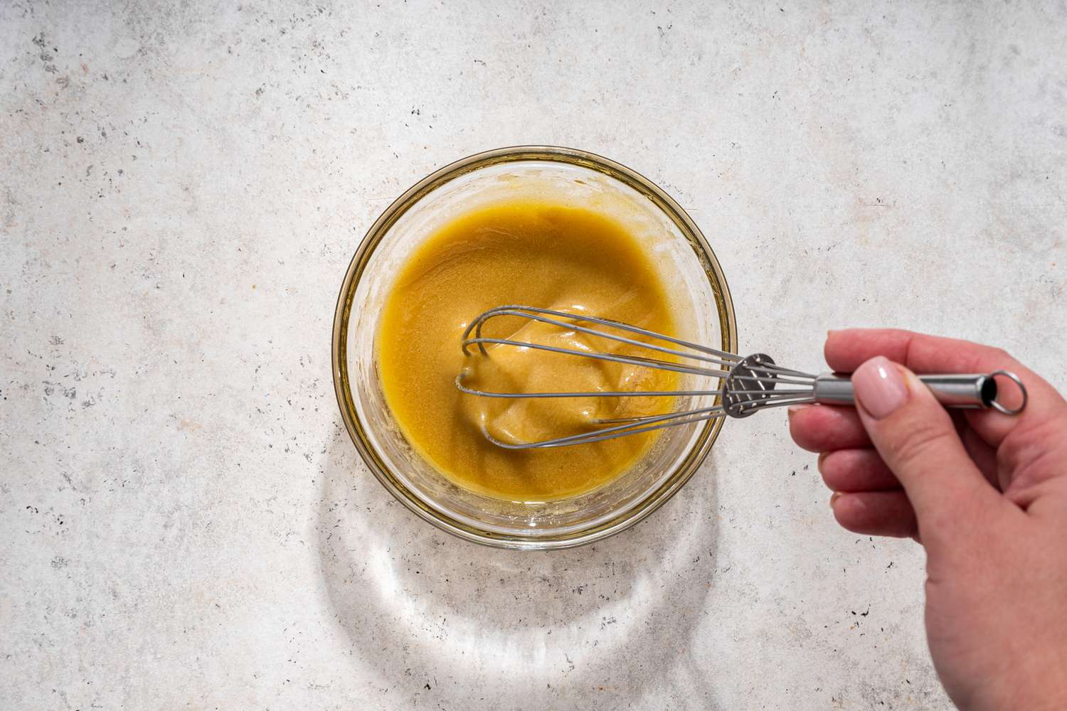 Dijon dressing whisked together in a bowl for Australian crash hot potatoes recipe