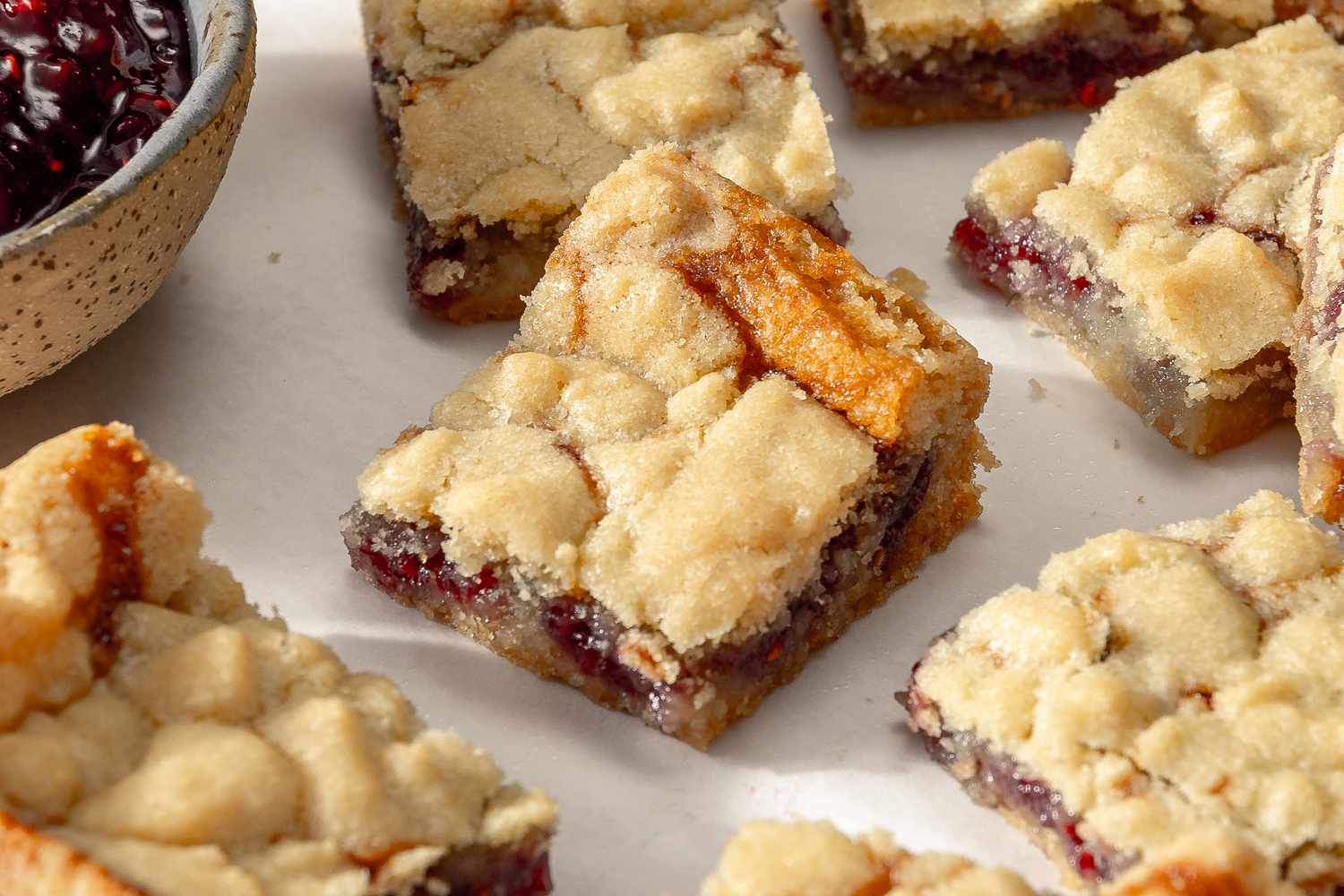 Side view of 2-ingredient jam bar squares on a white surface