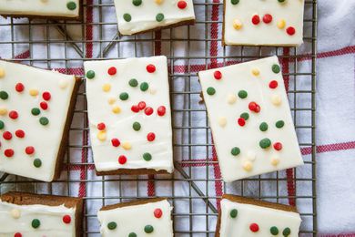 Gingerbread Bars frosted and decorated with festive sprinkles and set on a rack.