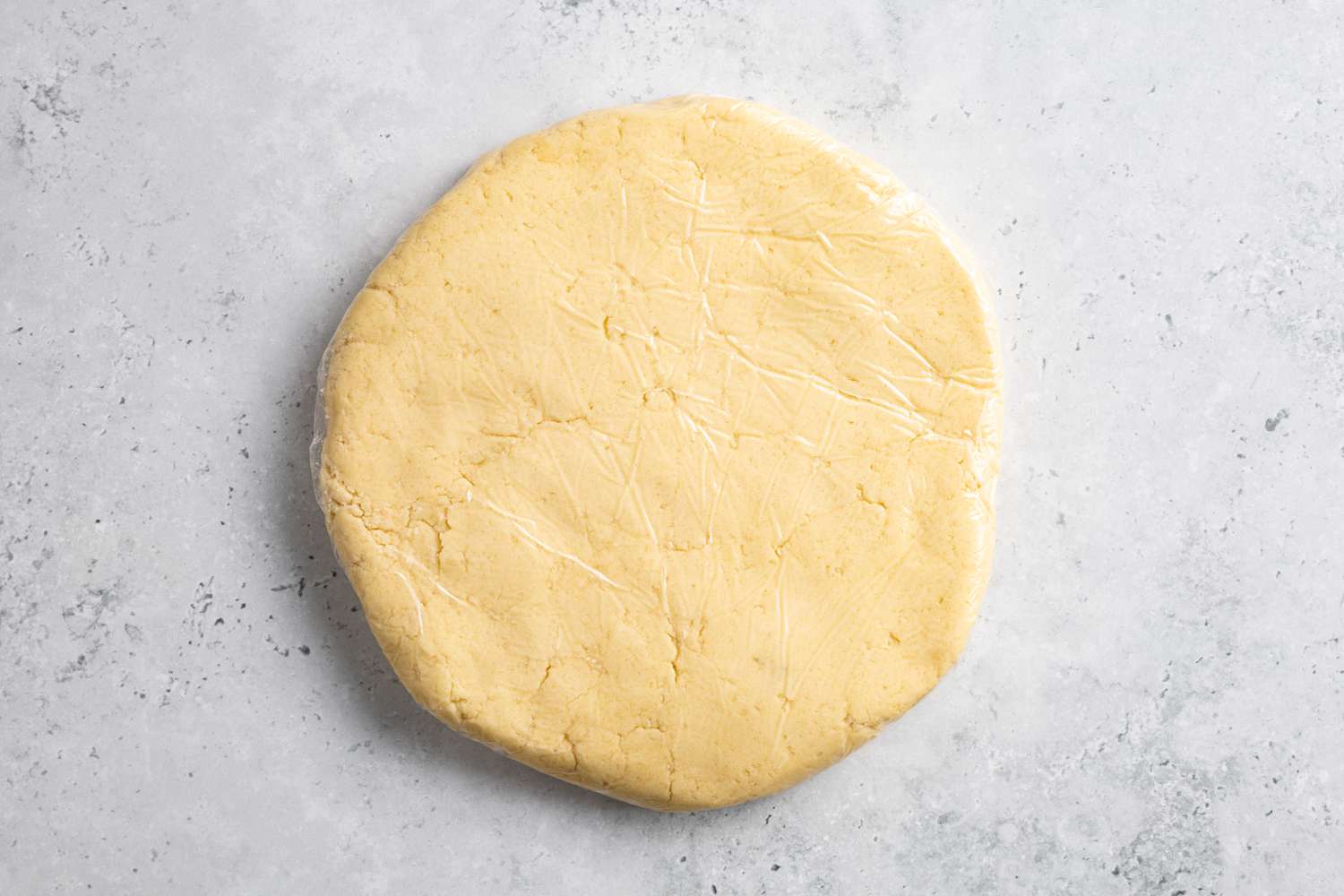 Disk of Classic Shortbread Cookie Dough Wrapped in Plastic Wrap for Cut-Out Cookies