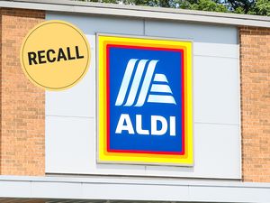 Aldi storefront with a recall symbol displayed