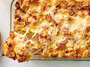 Croque monsieur breakfast casserole topped with melted cheese served in a glass baking dish
