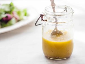 Homemade Honey Mustard Dressing - ball jar with honey mustard dressing wtih silver spoon