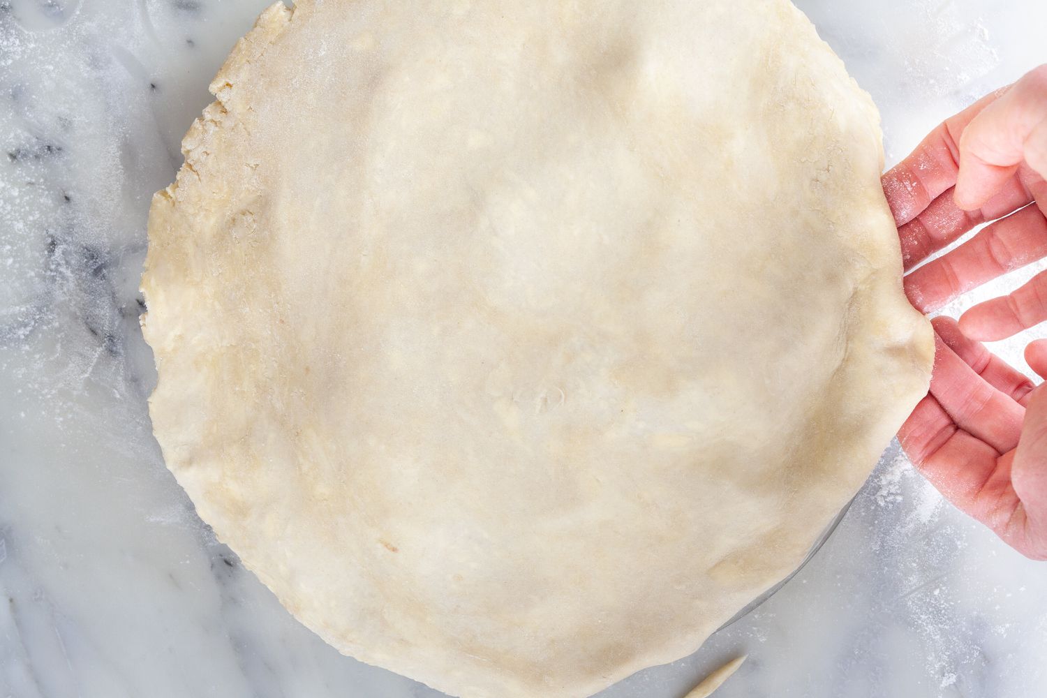 Adding the top crust to show how to make pie crust.