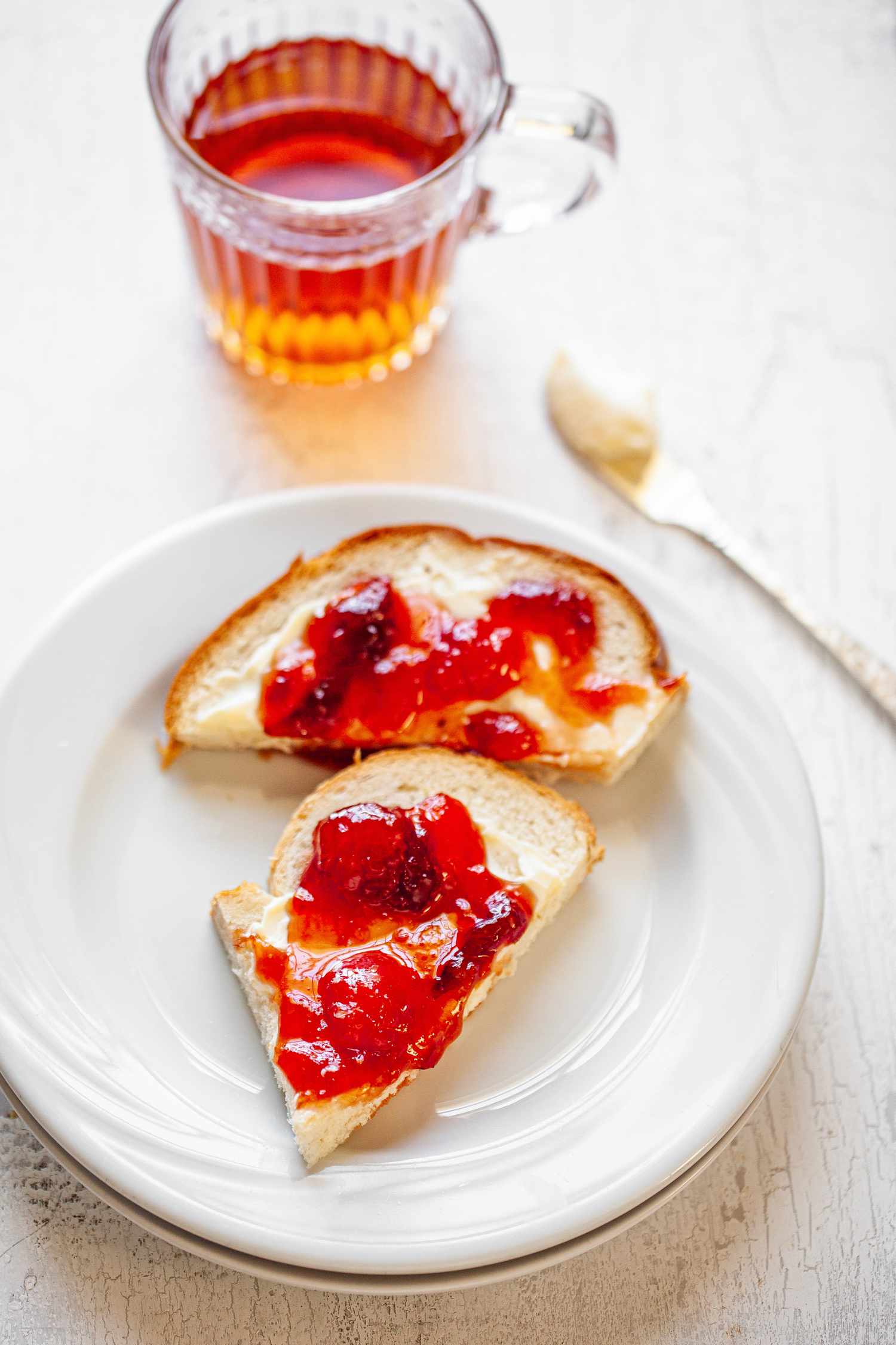 Peach, Pear, and Plum Jam on a Piece of Toast with Butter