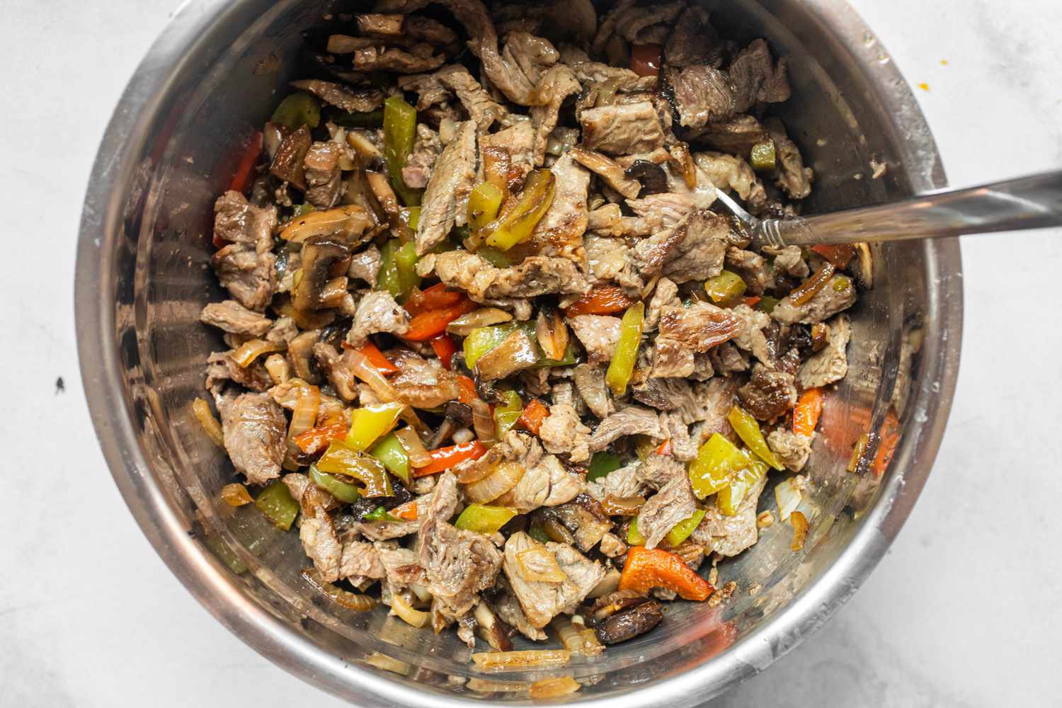 Philly Cheesesteak Stuffed Peppers Filling Mixed Together in a Bowl