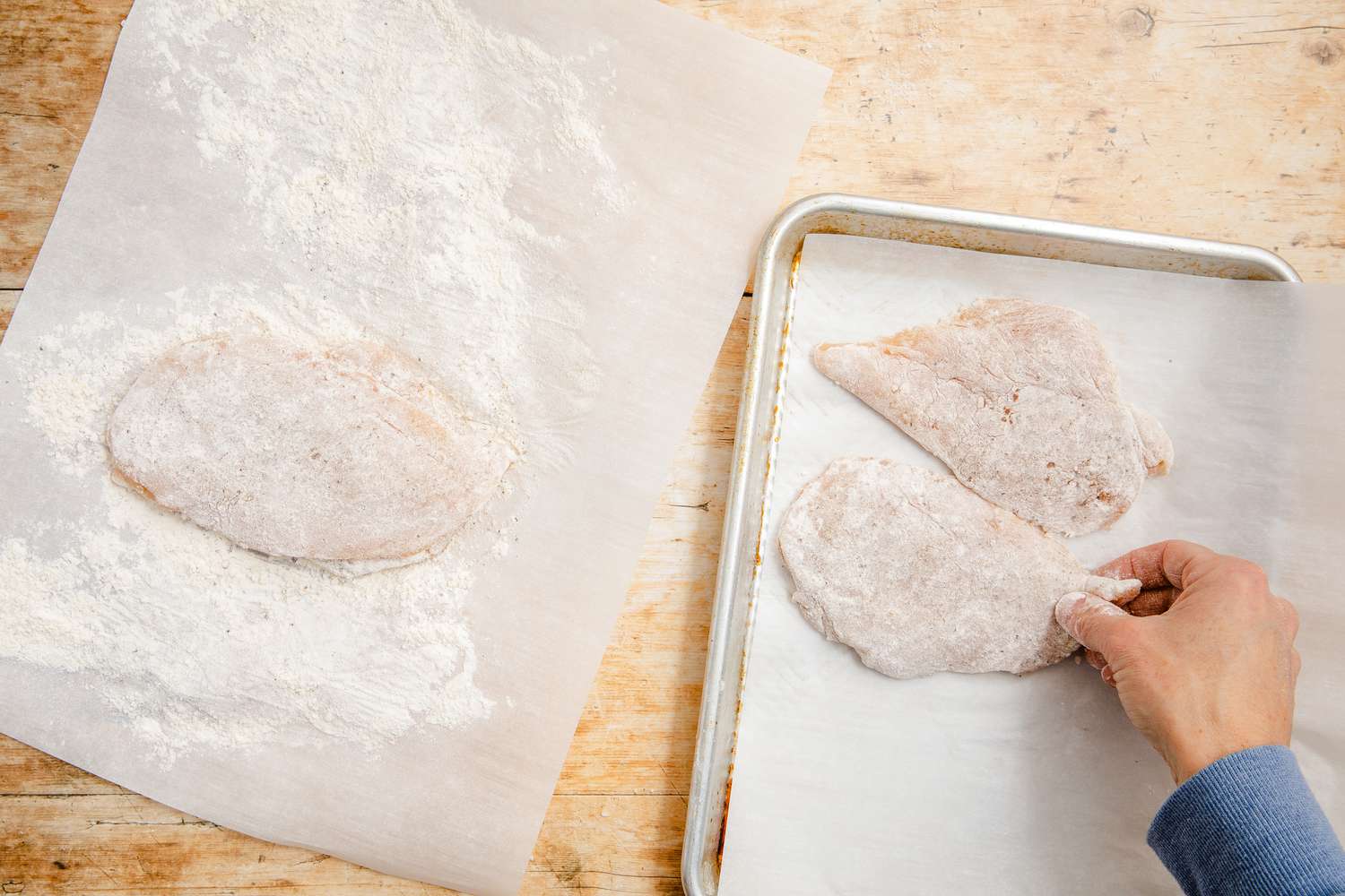 dredged chicken transfered to a baking sheet for chicken marsala recipe 