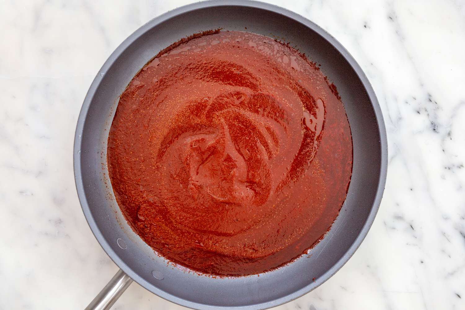 Red sauce in a skillet to make a chilaquiles recipe.