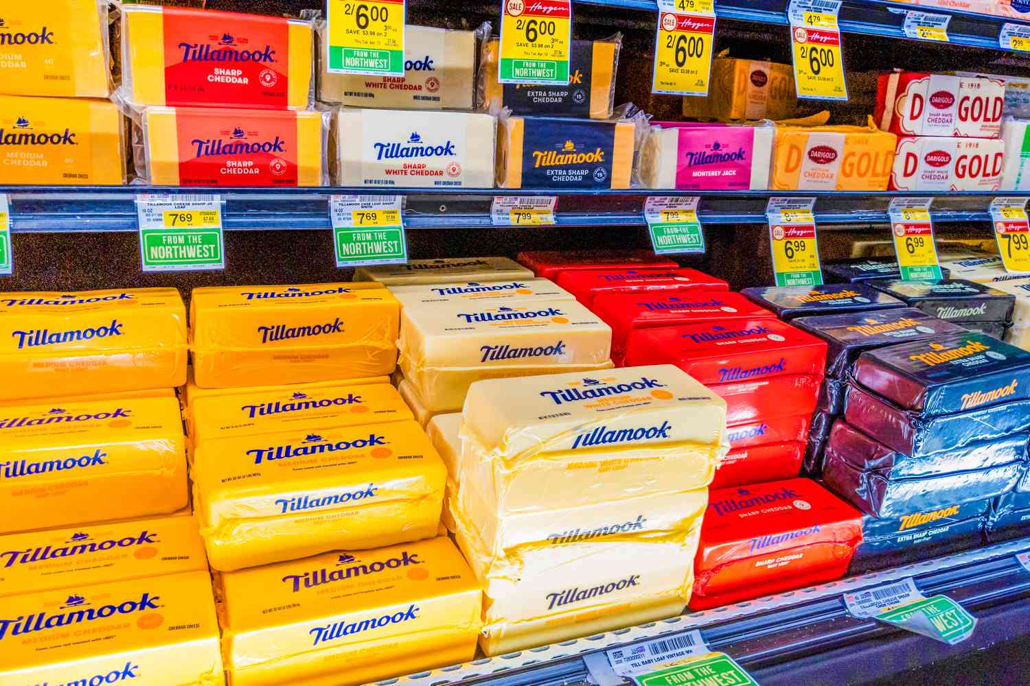 Angled view of Tillamook cheese bricks for sale in the refrigerated section of a Haggen Northwest Fresh grocery store