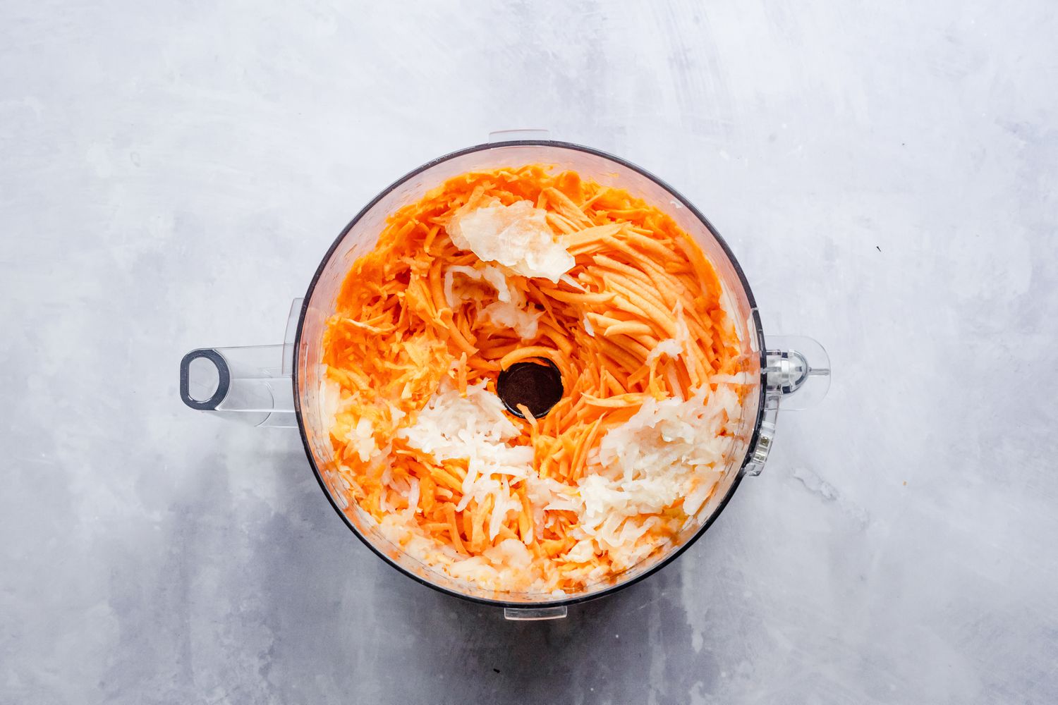 Sweet Potatoes and Onions Shredded in a Food Processor for Sweet Potato Latkes Recipe
