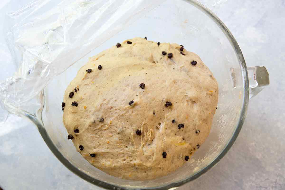 Risen dough for hot cross buns in a bowl