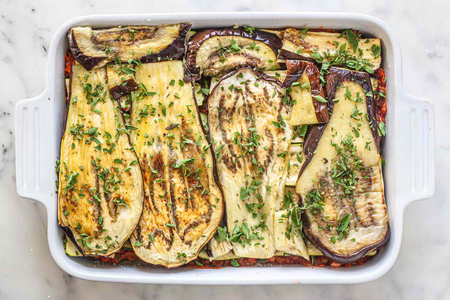Assemble vegetarian moussaka in casserole