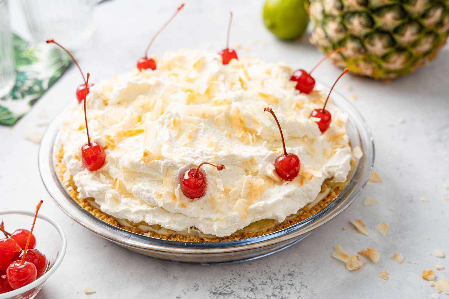 Piña Colada Pie Topped with Toasted Coconut Flakes and Maraschino Cherries