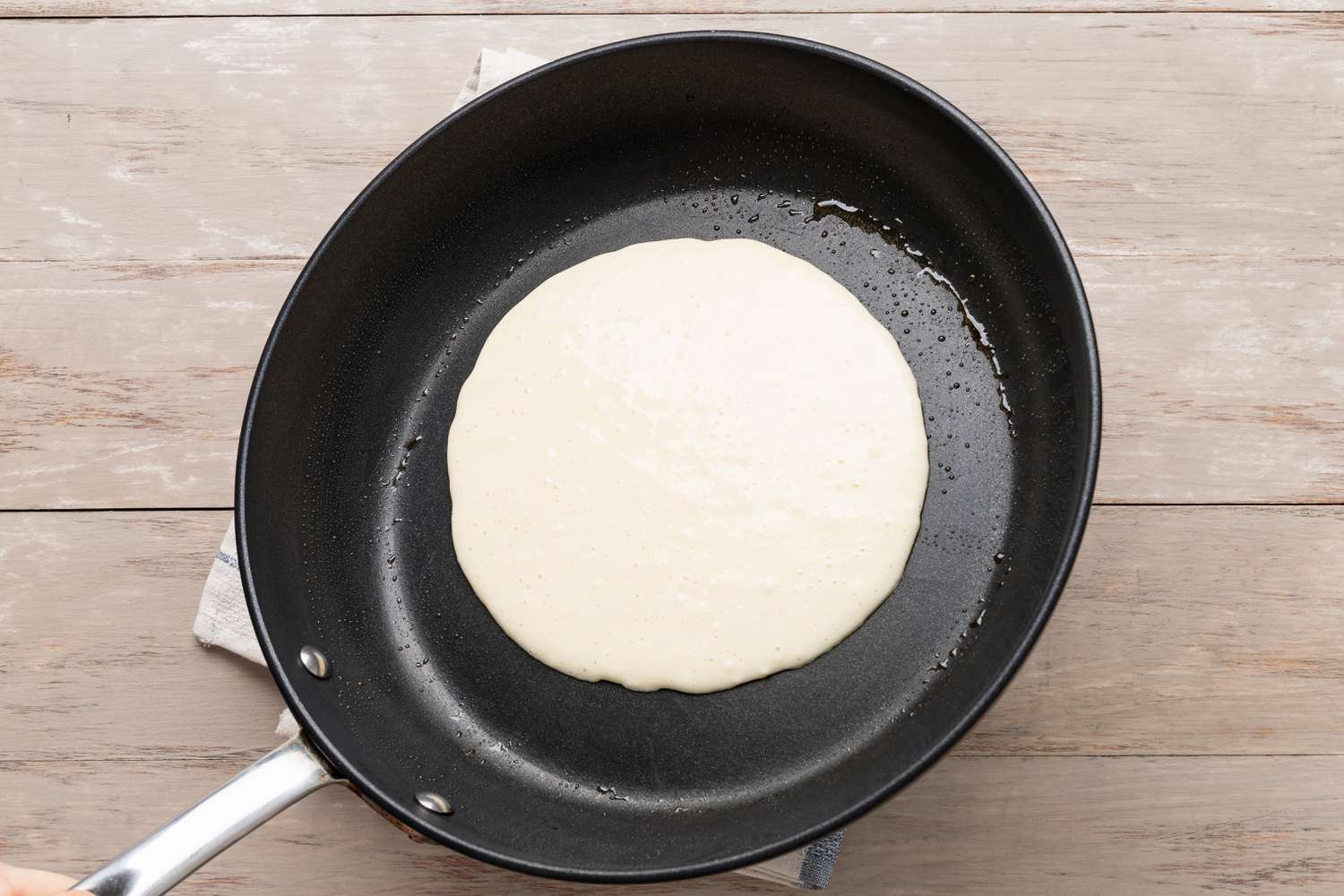 Pannenkoeken (Dutch Pancakes) batter added to heated skillet