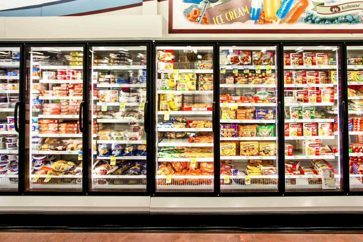 Frozen food aisle in a grocery store with shelves stocked with various packaged frozen items
