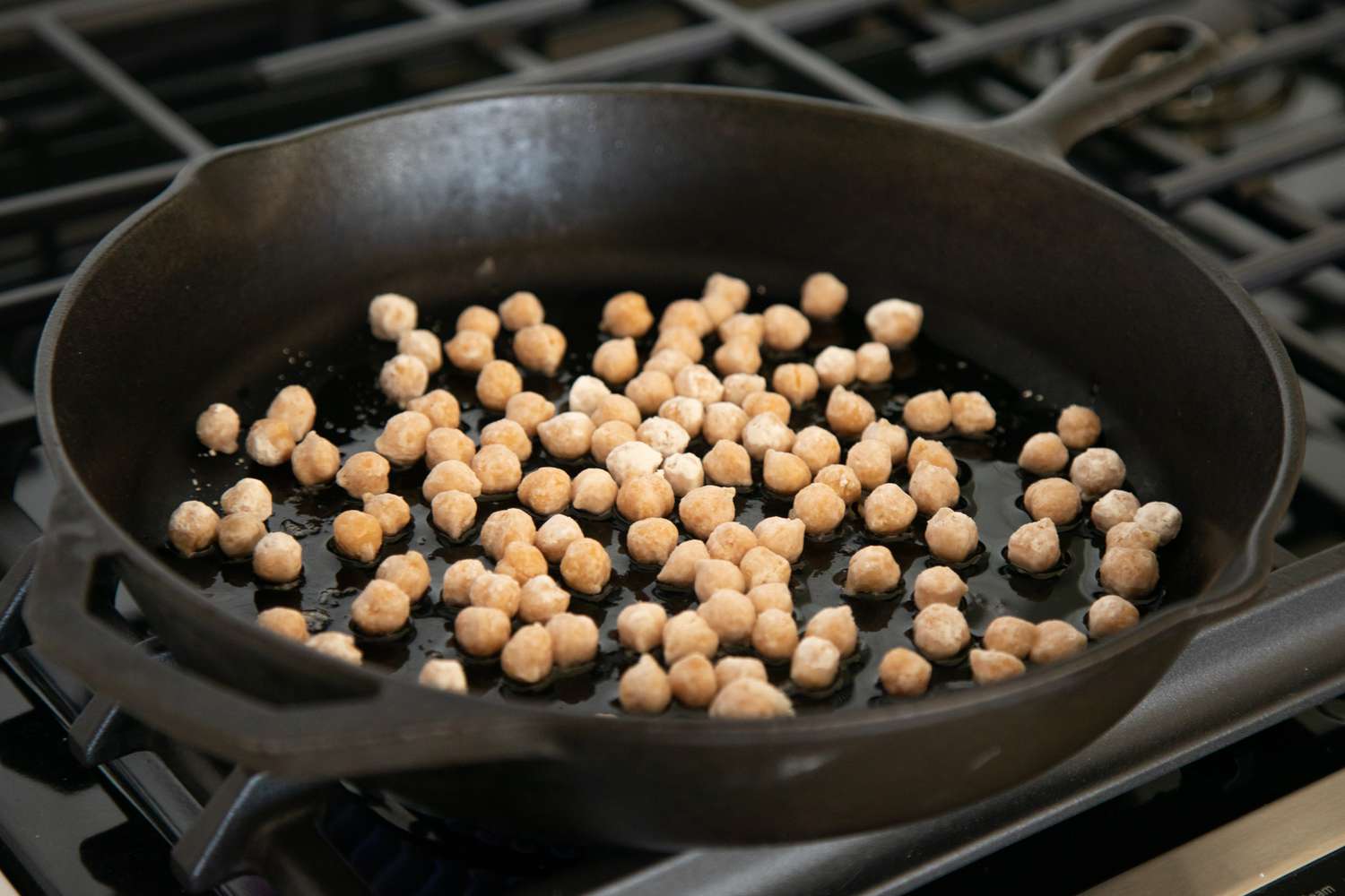 Frying chickpeas in a black cast iron skillet