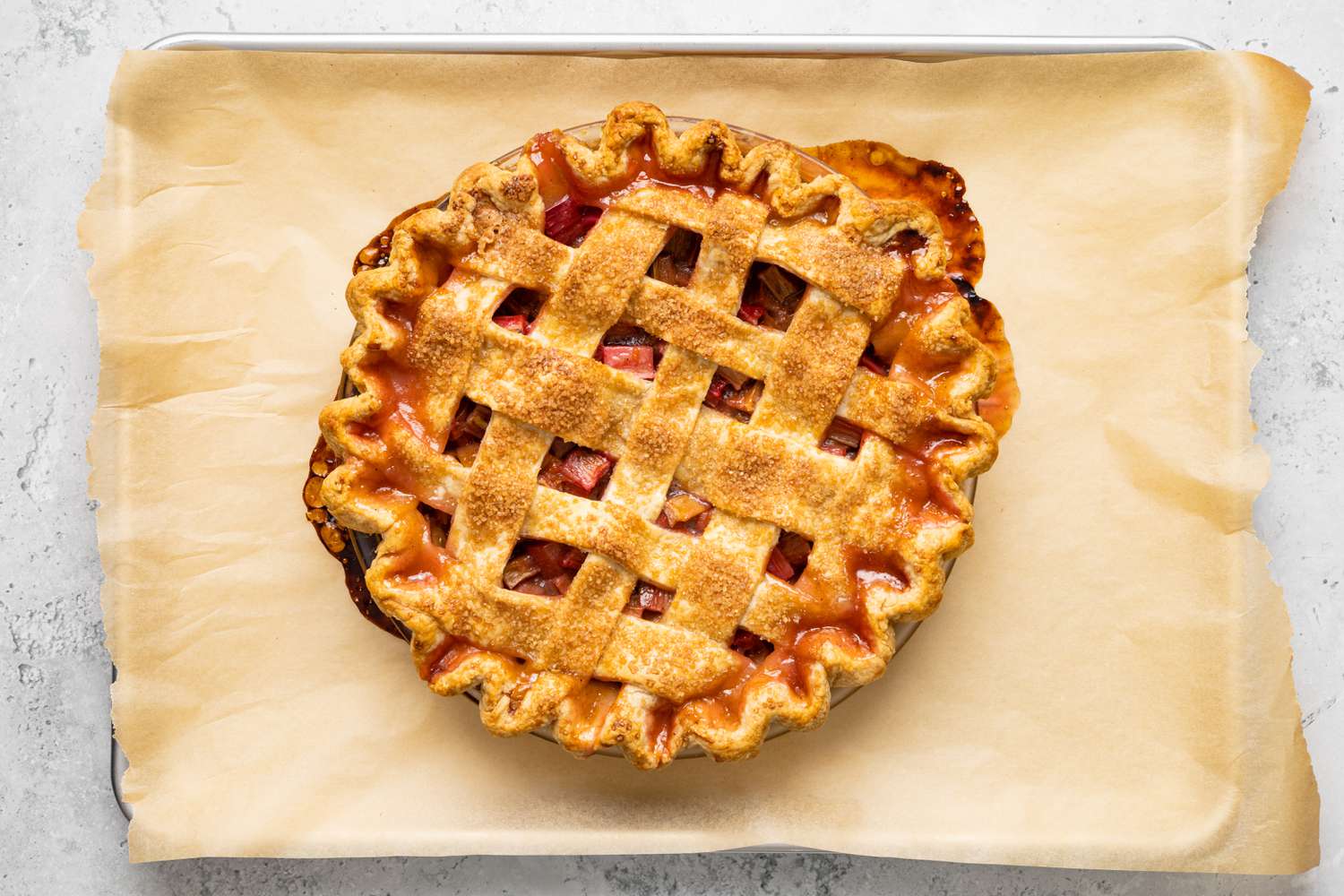 Cooked Rhubarb Pie on Baking Sheet Lined with Parchment Paper