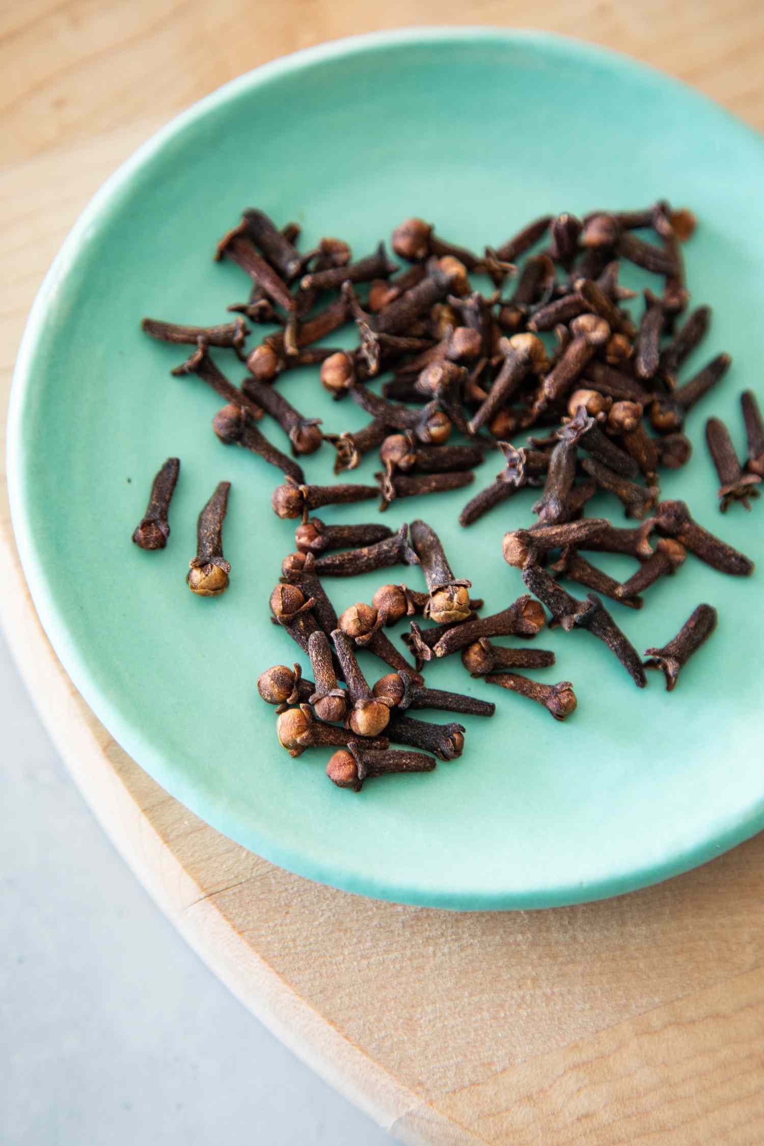 Cloves on a Small Plate on a Wooden Tray