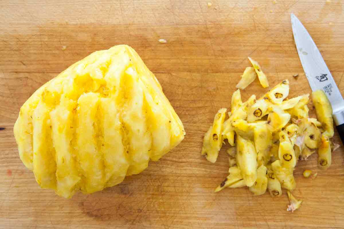 a cut pineapple with eyes removed, ready to slice