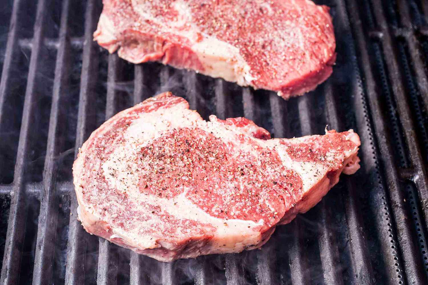 Set the ribeyes on the grill to cook