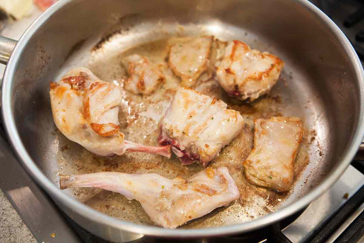 brown rabbit pieces on both sides for Rabbit in Mustard Sauce recipe