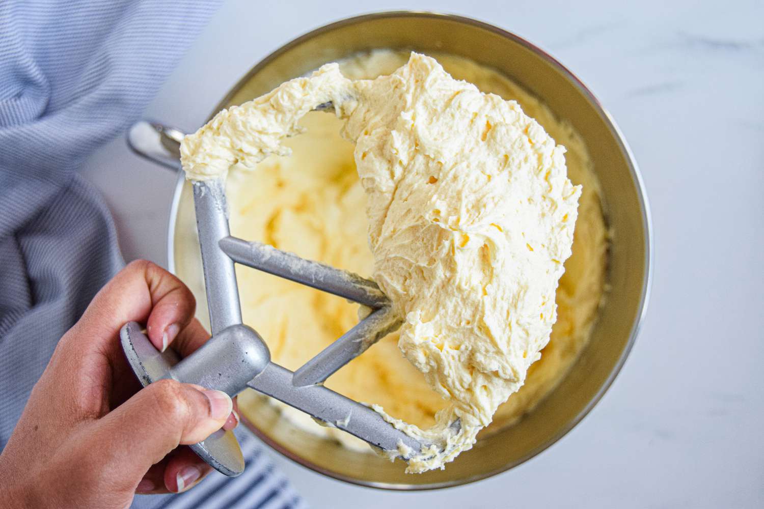 Fluffy beaten butter and sugar in a bowl for a chocolate bundt cake recipe