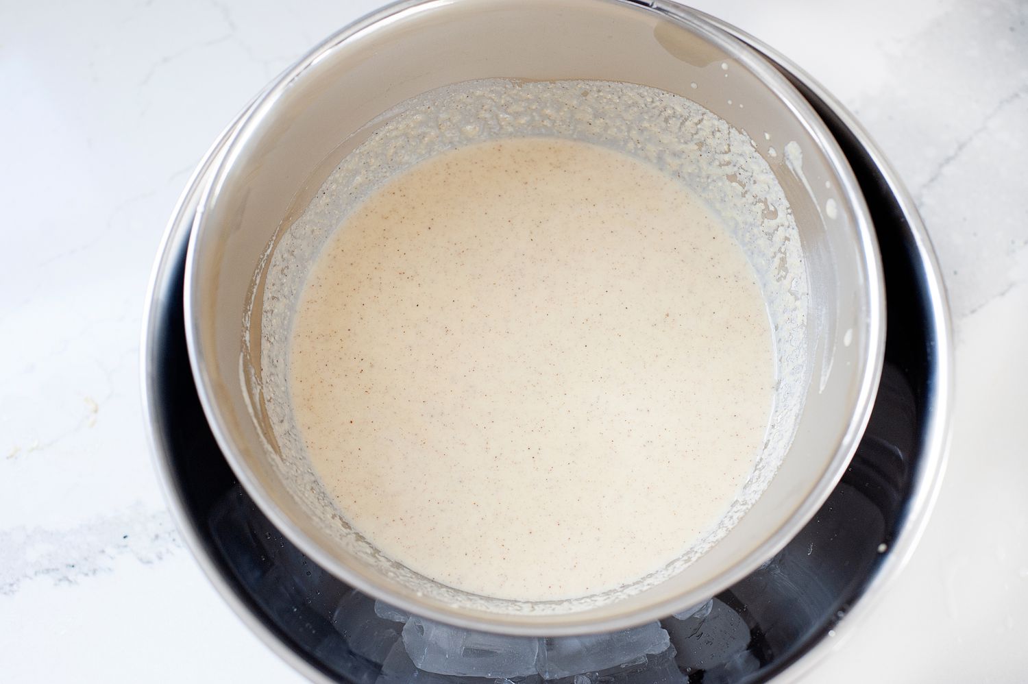 Cooling the base of cinnamon ice cream in an ice bath.