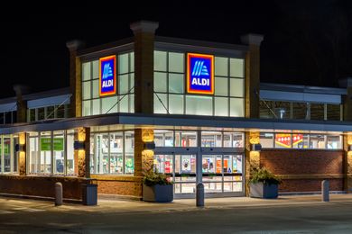 Exterior of an Aldi storefront illuminated at night
