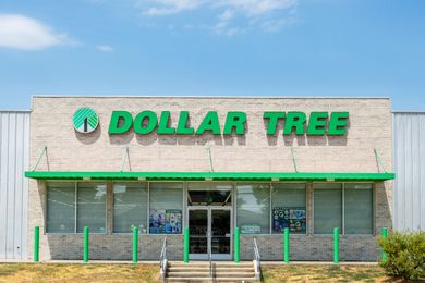 Exterior of a Dollar Tree store with a green logo and entrances visible