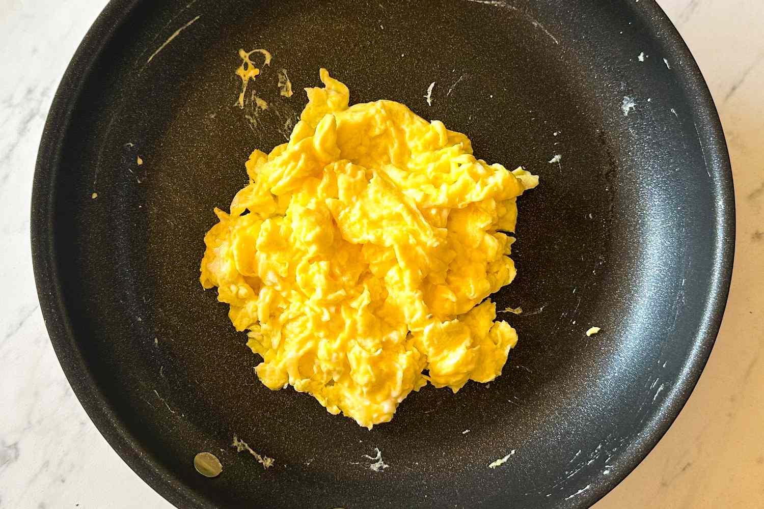Scrambled eggs in a frying pan