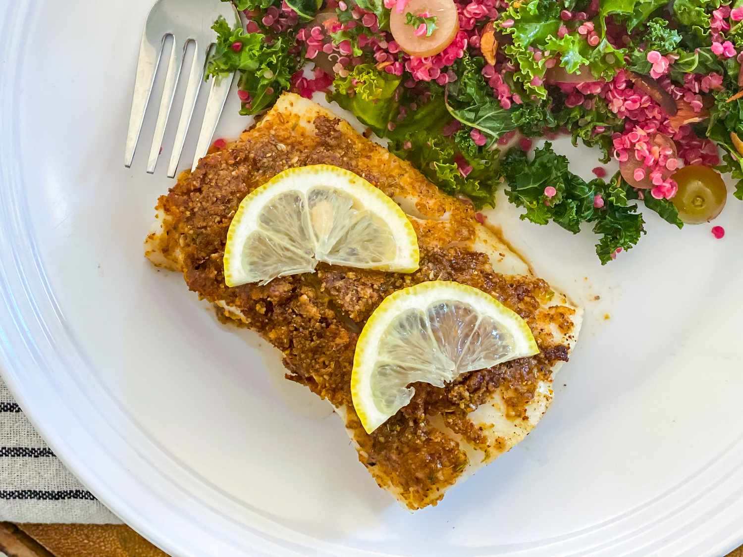 Egyptian spice blend on salmon and topped with lemon slices.